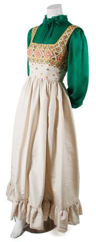 A Guy Laroche Couture Cream Satin Evening Gown,: A Guy Laroche Couture Cream Satin Evening Gown, 1970s, with geometric embroidery throughout bodice, full skirt with ruffled hemline, together with a green silk ruffled blouse. Labeled: Guy Laroche/tap