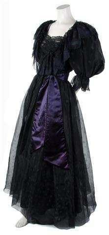 A Zandra Rhodes Black Silk Evening Gown, Size 10.: A Zandra Rhodes Black Silk Evening Gown, 1980s, with large puff sleeves, ruffle trim neckline with beaded trim, black net ruching at bust, full skirt with separate tulle underskirt, silk self belt at 