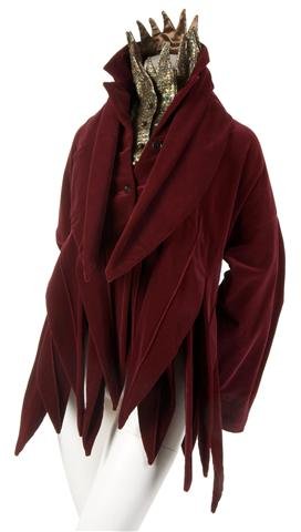 A Romeo Gigli 'Jester' Ensemble, Size 42.: A Romeo Gigli 'Jester' Ensemble, 1980s, comprised of a red velvet jester jacket with a gold glitter vest with a stand up collar, matching velvet sash. Labeled: Romeo Gigli. Size 42.
