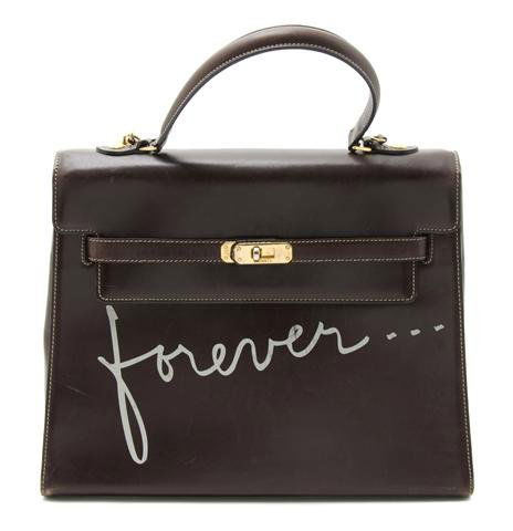 A Moschino 'Forever . . . ' Kelly Handbag, 12 x 10 inch: A Moschino 'Forever . . . ' Kelly Handbag, 1980s, in dark brown leather with a detachable shoulder strap, goldtone hardware, fully lined. Stamped: Moschino. 12 x 10 inches.