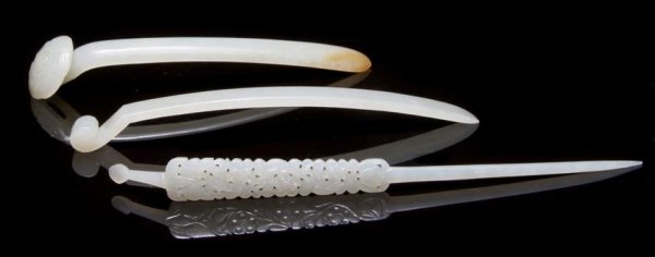 A Group of Three Chinese Jade Hairpins, Length of longe: A Group of Three Chinese Jade Hairpins, of white stone, one in the form of a ruyi scepter with relief carving on the head, one with scrolled head and the other having a pierced floral pattern througho