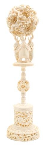 A Chinese Elephant Ivory Puzzle Ball and Stand, Height : A Chinese Elephant Ivory Puzzle Ball and Stand, the ball carved with dragons throughout, containing at least 13 separate spheres, the stand having three elephants at top above with a separate puzzle b