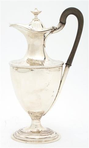 An English Silver Ewer, Walker and Hall, Height 10 1/4 : An English Silver Ewer, Walker and Hall, Sheffield, 1916, having an urn form finial and wood handle; approximate weight overall 17.91 ozt. Height 10 1/4 inches.