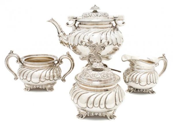 An American Sterling Silver Tea Set, Theodore Starr, He: An American Sterling Silver Tea Set, Theodore Starr, comprising a hot water kettle on stand, creamer, covered sugar and waste pot; approximate total weight 78.08 ozt. Height of tallest 11 1/2 inches.