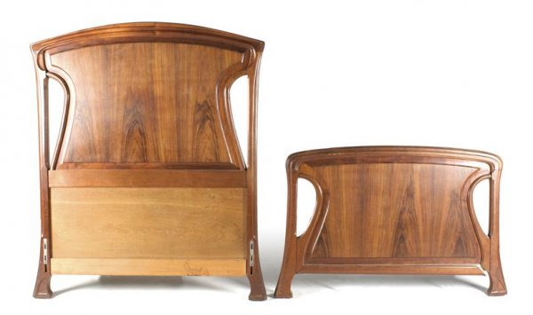 A French Art Nouveau Single Bed, Height 54 inches.: A French Art Nouveau Single Bed, having a domed headboard and footboard with pierced sides raised on splayed supports. Height 54 inches.