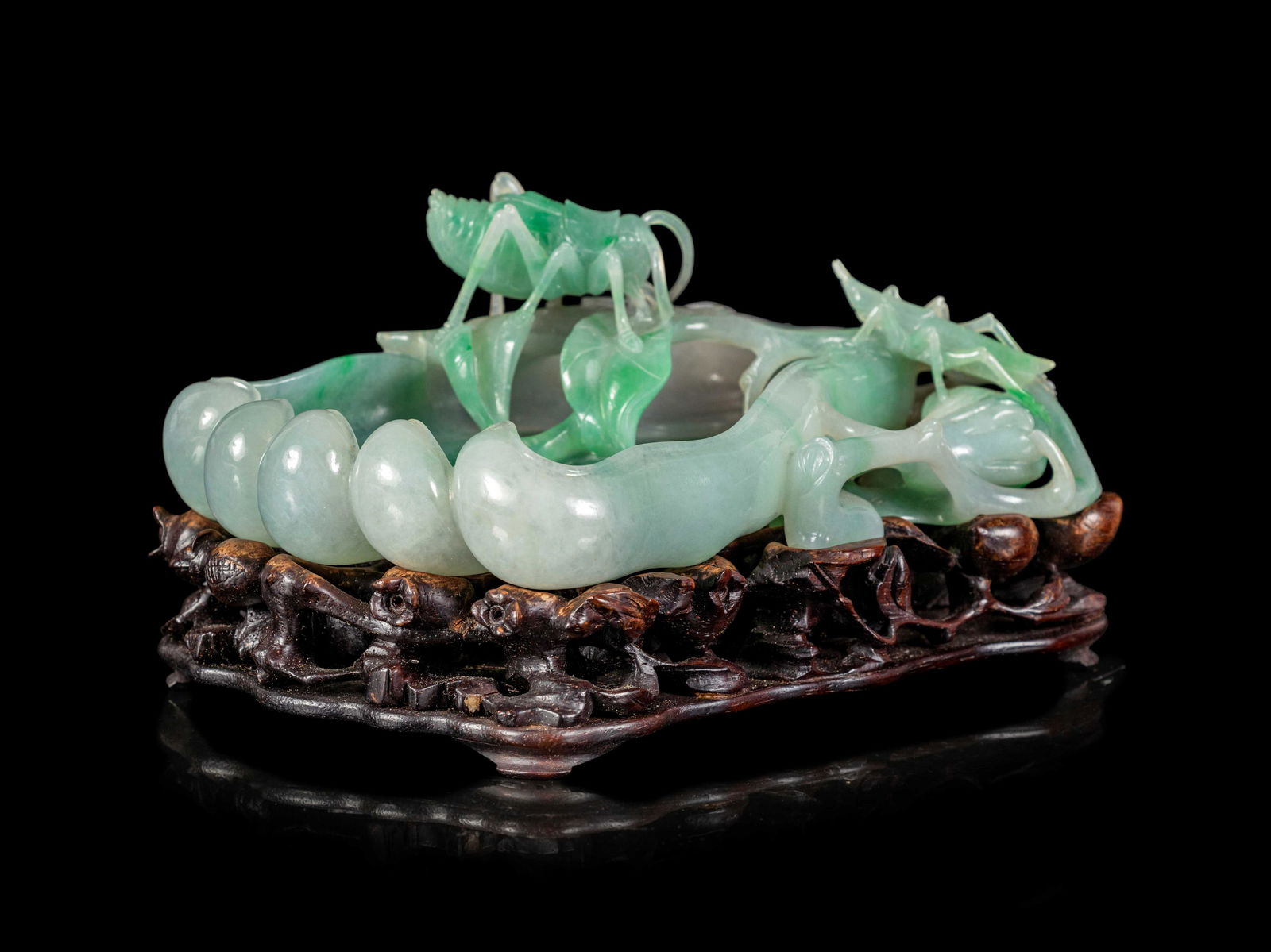 An Apple Green and White Jadeite 'Buddha's Hand Citron (1 of 4)
