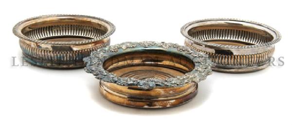 A Pair of Silverplate Wine Coasters, diameter of widest: A Pair of Silverplate Wine Coasters, with gadrooned edges together with another example having grape vine and cluster motif. diameter of widest 7 inches.