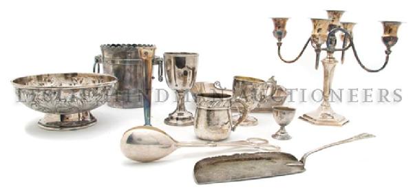 A Collection of Eleven Silverplate Articles, Height of : A Collection of Eleven Silverplate Articles, comprising an ice bucket, footed bowl, rectangular tray, two cups, small trumpet vase, chalice, egg cup, candelabrum and two others. Height of first 6 inch