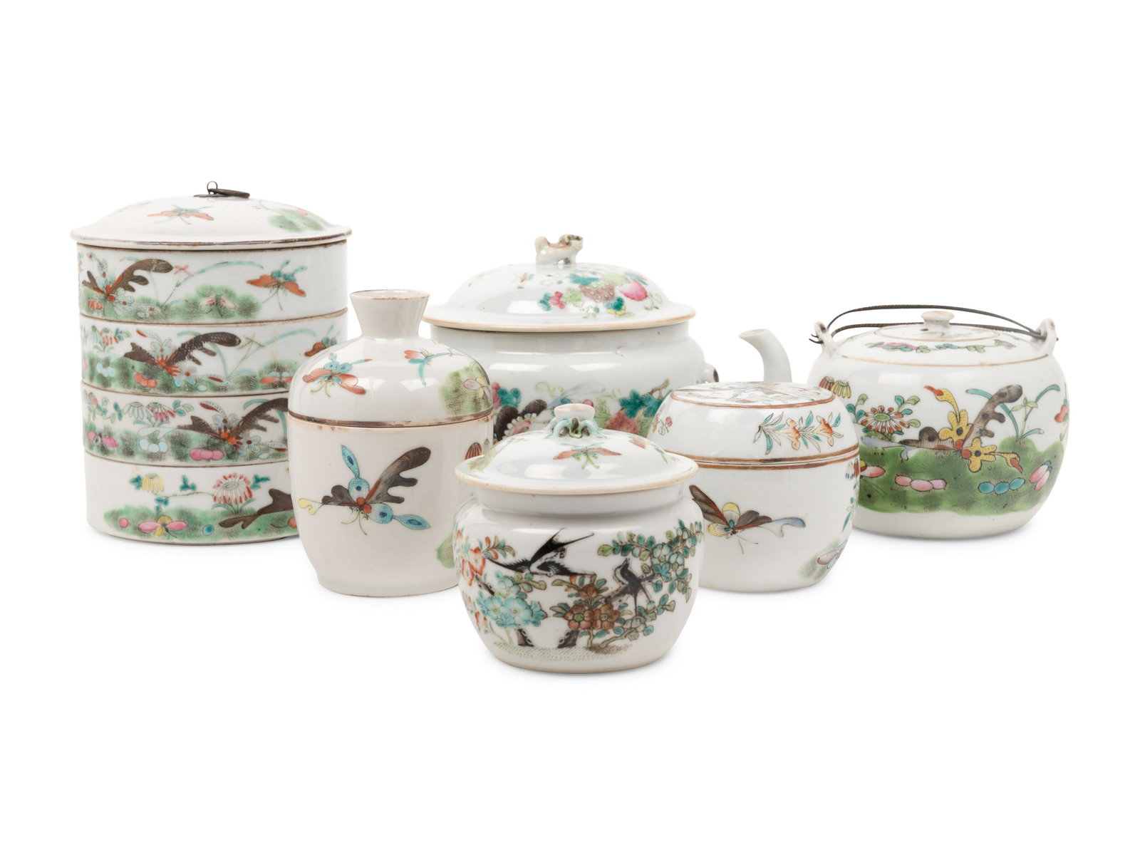 Six Chinese Famille Rose Porcelain Wares: Six Chinese Famille Rose Porcelain Wares MID 20TH CENTURY comprising a four-tiered container and cover, two covered jars, a wine warmer, a teapot, and a circular covered box. Width of largest vessel 6