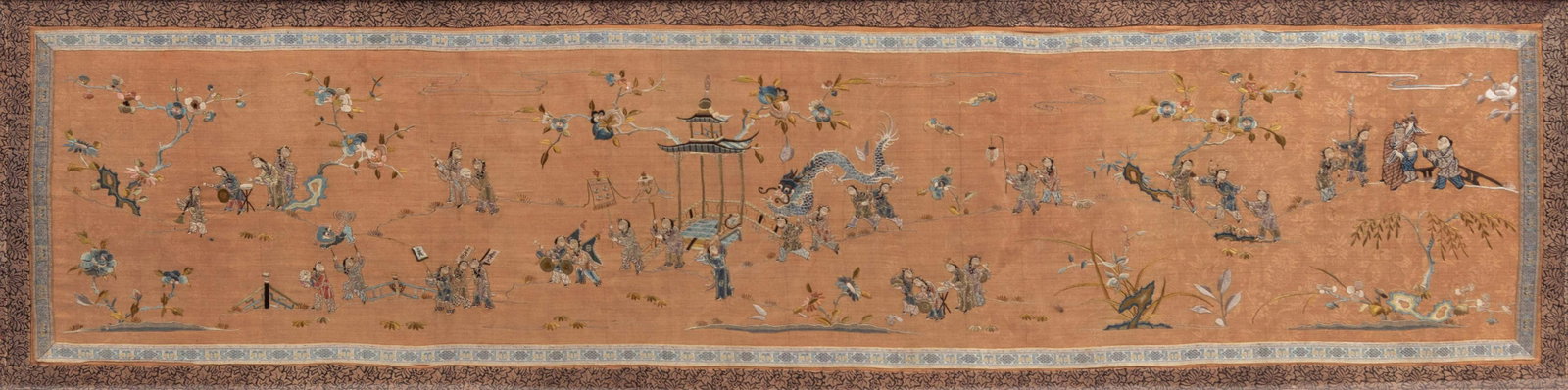 A Chinese Coral Ground Embroidered Silk 'Boys Panel: A Chinese Coral Ground Embroidered Silk 'Boys Panel 19TH CENTURY of long rectangular section bordered in cream ground ribbon and gold brocade, delicately worked in satin stitches against the damask gr
