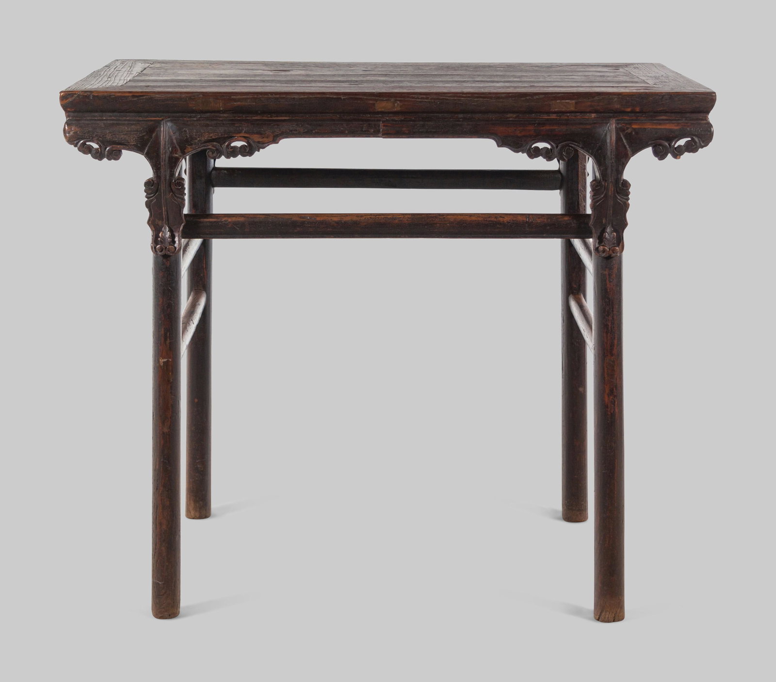 A Chinese Black Lacquered Softwood Wine Table, Jiuzhuo: A Chinese Black Lacquered Softwood Wine Table, Jiuzhuo 19TH CENTURY having a rectangular top set within a metered frame set above a plain apron and shaped scroll spandrels. The four cylindrical legs j