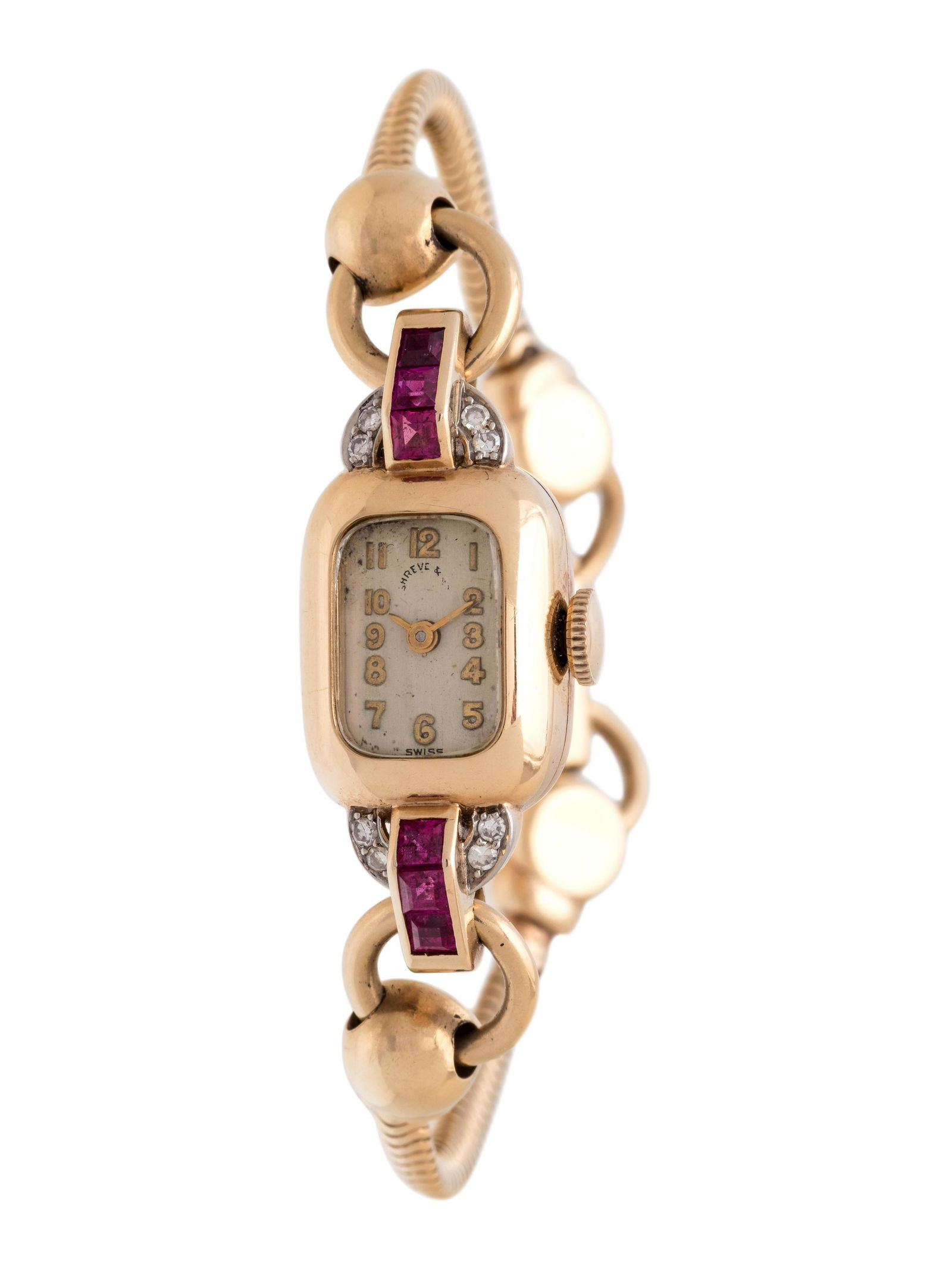 CRESARROW, SHREVE & CO., 14K YELLOW GOLD, SYNTHETIC: CRESARROW, SHREVE & CO., 14K YELLOW GOLD, SYNTHETIC RUBY AND DIAMOND WRISTWATCH 17.00 x 12.00 mm case dimensions, the lugs containing six square step cut synthetic rubies and eight single cut diamonds