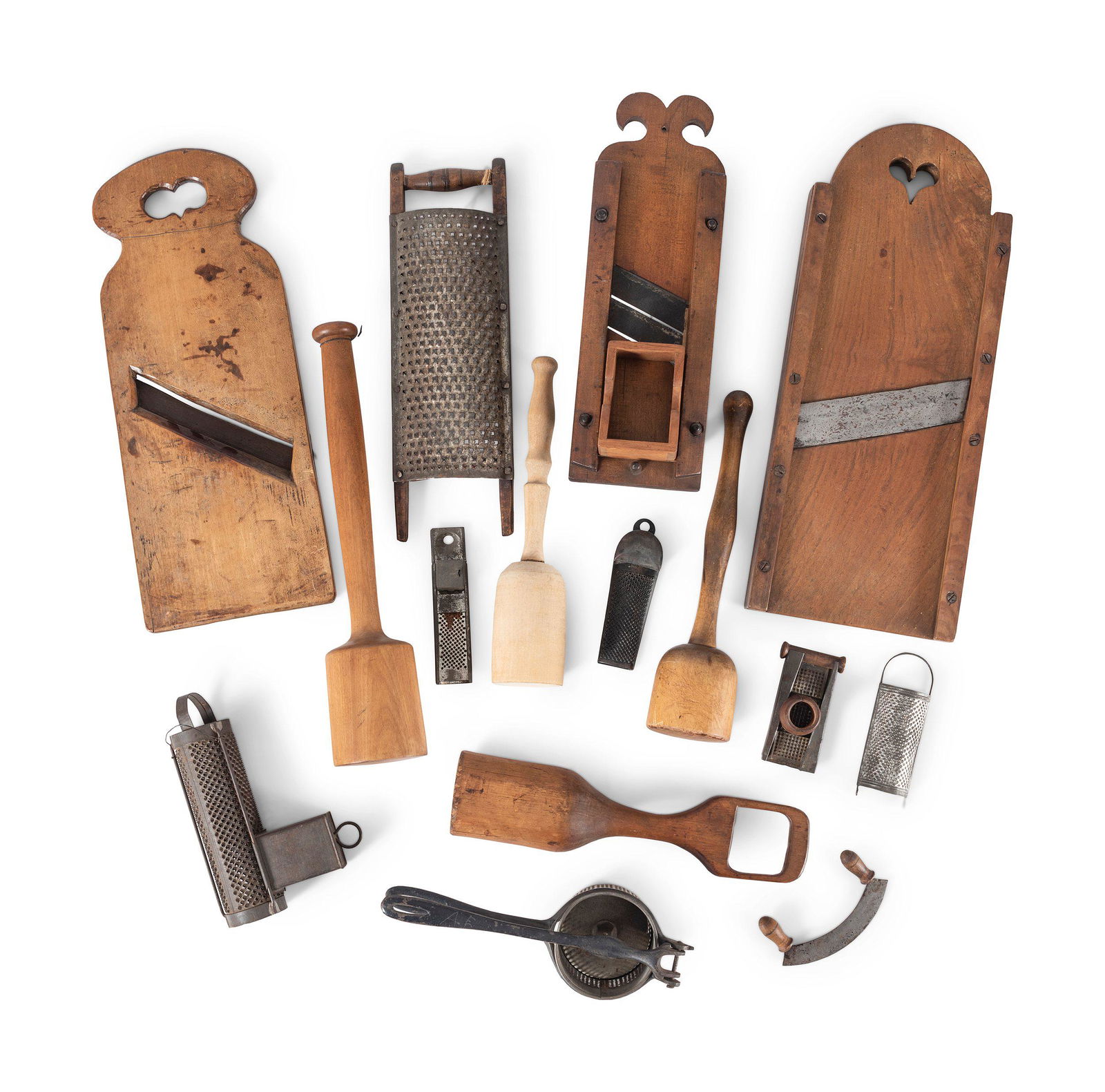 A Group of Wood and Tin Graters, Slicers and Pounders: A Group of Wood and Tin Graters, Slicers and Pounders 19th Century comprising four pounders, a masher, six graters, three slicers and a two-handle chopper; 15 items total. Height of largest slicer 19