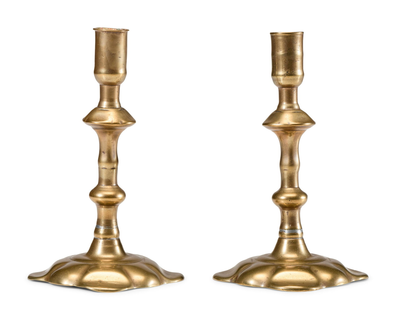 A Pair of English Brass Scalloped-Foot Candlesticks: A Pair of English Brass Scalloped-Foot Candlesticks 18th Century Height 7 inches. Property from the Estate of Paul Thomas Griffith, Dayton, Ohio