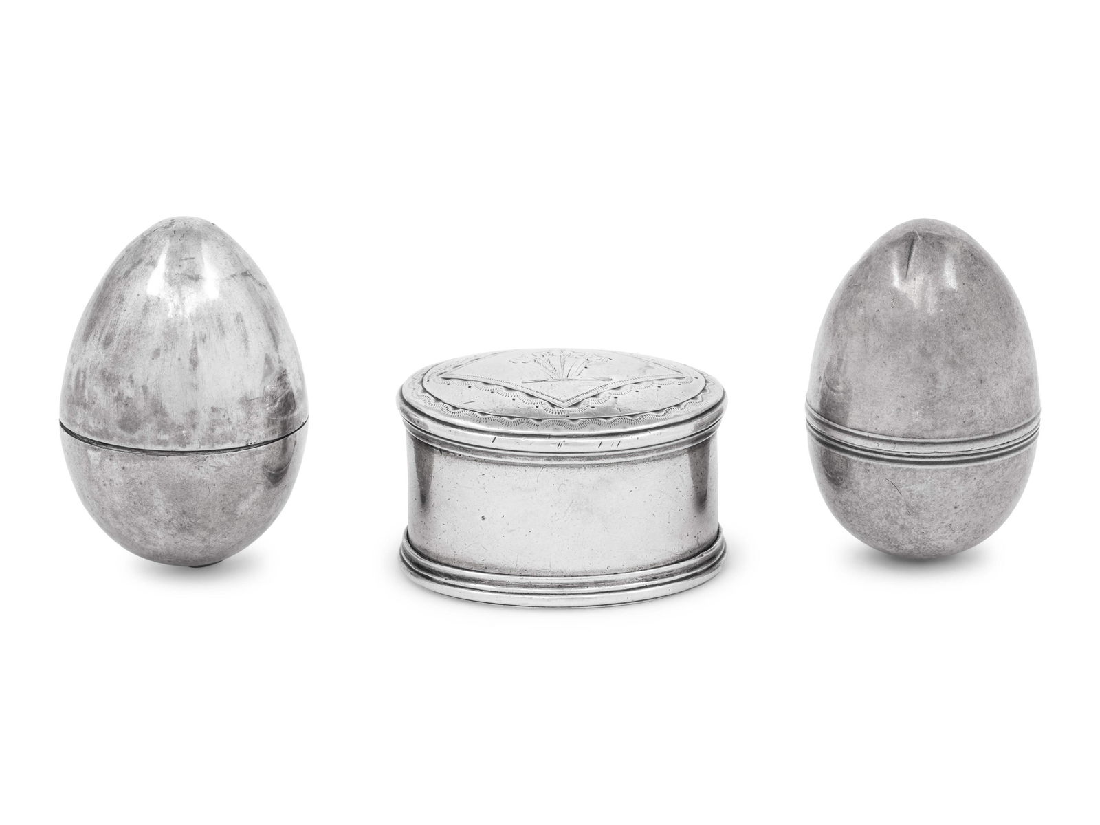 Three Georgian Silver Nutmeg Graters: Three Georgian Silver Nutmeg Graters Various makers, Circa 1800 comprising two ovoid form and one oval box example. each hallmarked for Sterling 2 ozt 14 dwt gross Width of largest 1 7/8 inches. Prope
