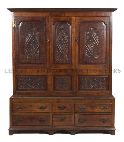 A Welsh Oak Linen Press, Height 79 x width 68 x depth 2: A Welsh Oak Linen Press, having two drawers over six drawers with carved decoration throughout raised on bracket feet. Height 79 x width 68 x depth 21 1/2 inches.