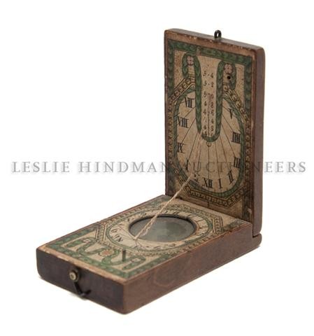 A Wood and Printed Paper Sundial, Width 1 5/8 x depth (: A Wood and Printed Paper Sundial, 18th century, with hook and loop latch. Width 1 5/8 x depth (closed) 2 5/8 inches. Property from the Museum of Science and Industry, Chicago, Illinois