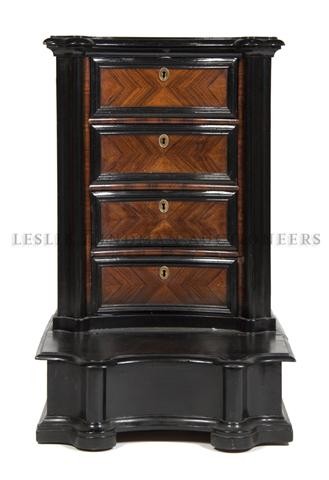 An Ebonized and Burlwood Prie-Dieu, Height 34 inches: An Ebonized and Burlwood Prie-Dieu, of concave form, set with four drawers, the kneeler lifting to reveal a compartment. Height 34 inches Property from the Collection of Mr. John Mix, Chicago, Illinoi