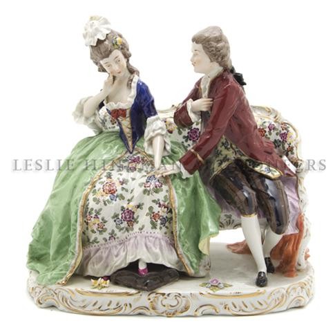 A Capodimonte Porcelain Figural Group, Height 10 inches: A Capodimonte Porcelain Figural Group, depicting a courting couple in 18th century costume seated on a bench, having crowned N mark. Height 10 inches.