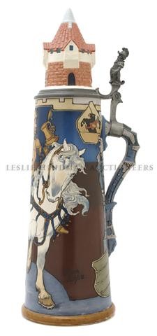 A Mettlach Stein, Heinrich Schlitt, Height is 24 inches: A Mettlach Stein, Heinrich Schlitt, model number 2764, the lid surmounted with a castle turret, having figural pewter mount, decorated with a knight on horseback drinking from a stein. Height is 24 in
