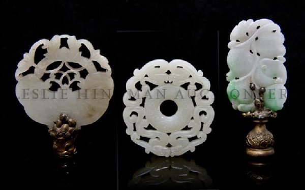A Group of Three Chinese Carved Jade Articles, Dia: A Group of Three Chinese Carved Jade Articles, comprised of a near white bi surrounded by dragons, a celadon butterfly motif disk and a jadeite green and white plaque with floral and peach decoration.