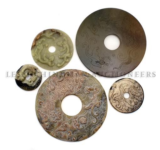 A Collection of Five Hardstone Bi, Diameter of lar: A Collection of Five Hardstone Bi, of various sizes and decoration, each depicting serpentine beasts. Diameter of largest 8 inches. Property from the Estate of Mr. Melvin Bullard, Chicago, Illinois