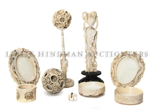 A Collection of Chinese Carved Ivory Articles, Hei: A Collection of Chinese Carved Ivory Articles, comprised of a puzzle ball and stand, a single puzzle ball, two oval ivory frames with double dragon design, a small ivory elephant, a figure of a woman 