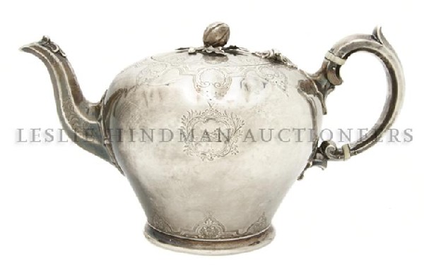 An English Silver Teapot, Edward, Edward Junior, J: An English Silver Teapot, Edward, Edward Junior, John & William Barnard, 1840, London, of ovoid form, having a melon form finial, the body and lid with shell and foliate decoration, the handle with iv