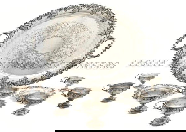 A Silverplate Wine Set, Height of first 15 1/4 inc: A Silverplate Wine Set, comprising a decanter, an oval tray, two plates and eight cups. Height of first 15 1/4 inches. Property from the Collection of Mr. John Mix, Chicago, Illinois