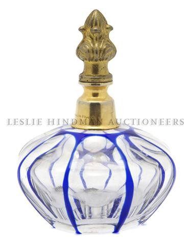 A Baccarat Glass Perfume Bottle, Diameter 3 1/2 in: A Baccarat Glass Perfume Bottle, the octagonal body in blue cut to clear, lacking atomizer, having Baccarat acid stamp. Diameter 3 1/2 inches. Property of a Private Southeast Michigan Collector