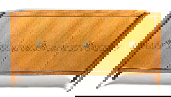 A Belgian Art Deco Style Sideboard, Design by De: A Belgian Art Deco Style Sideboard, Design by De Coene Fr?res, having a shaped top over three paneled doors having applied gilt metal escutcheons, opening to a fitted interior raised on tapering legs,