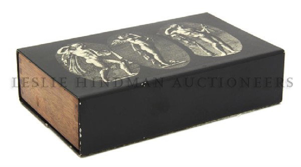 An Italian Metal and Wood Box, Fornasetti, Height: An Italian Metal and Wood Box, Fornasetti, having three ovals depicting classical figures. Height 2 x width 7 x depth 4 1/2 inches. Property from the Collection of Robert J. Jedlick, Darien, Illinois
