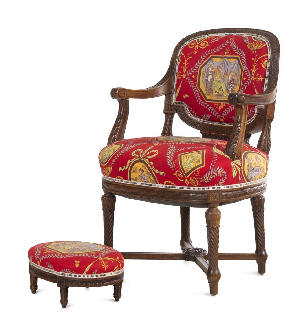 A Louis XVI Style Carved Armchair and Stool with: A Louis XVI Style Carved Armchair and Stool with Fortuny Upholstery 19th Century Height of chair 36 x width 23 x depth 22 inches. Property from a Private Collection, Detroit, Michigan