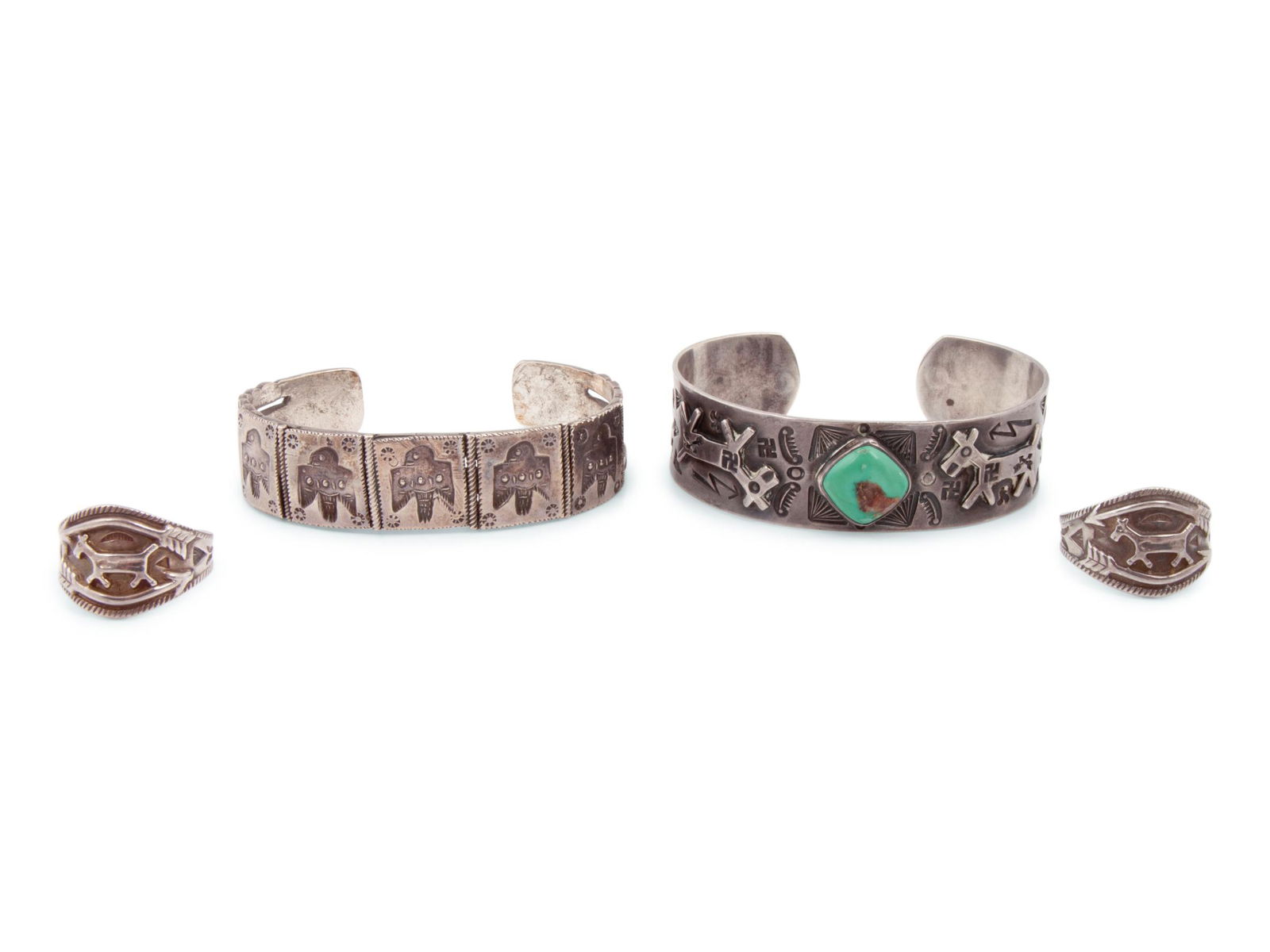 Fred Harvey Era Navajo Silver Cuff Bracelets and Rings: Fred Harvey Era Navajo Silver Cuff Bracelets and Rings early 20th century lot of 4, includes: a heavily stamped silver cuff, set with a central turquoise cabochon accented with silver applique dogs wi