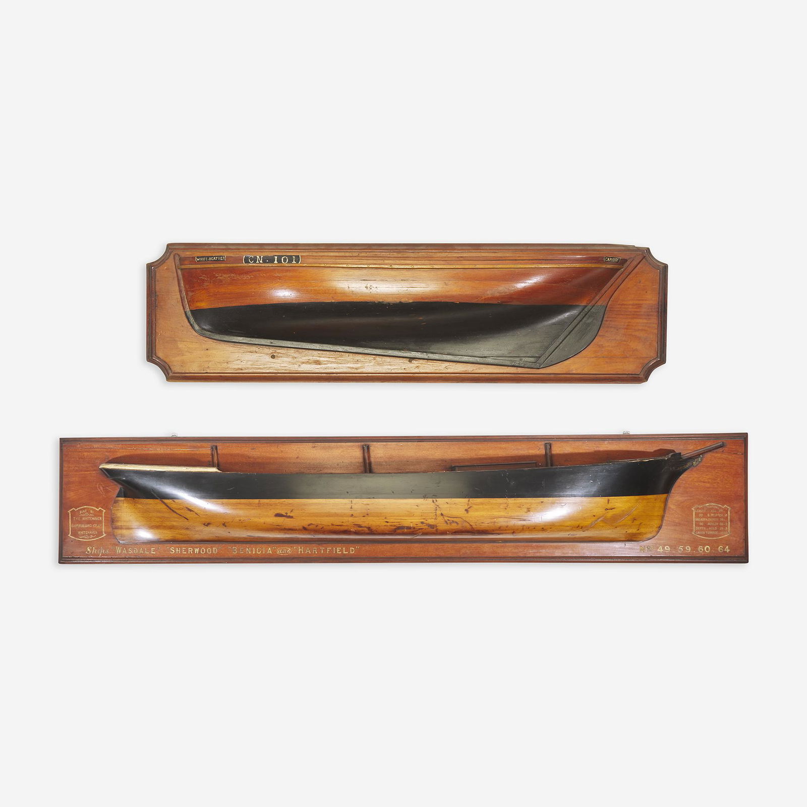 Two carved and painted half hull ship models late: Two carved and painted half hull ship models late 19th/early 20th century The larger example depicting ships Wasdale, Sherwood, Benicia and Hartfield, the smaller model depicting the White Heather.