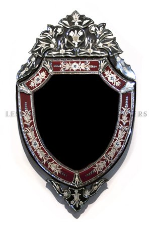 A Venetian Glass Mirror, Height 31 1/2 x width 19 inche: A Venetian Glass Mirror, the shield form beveled plate beneath a foliate crest, having cranberry panels. Height 31 1/2 x width 19 inches. Property from the Collection of Jeff Foster, Chicago, IL