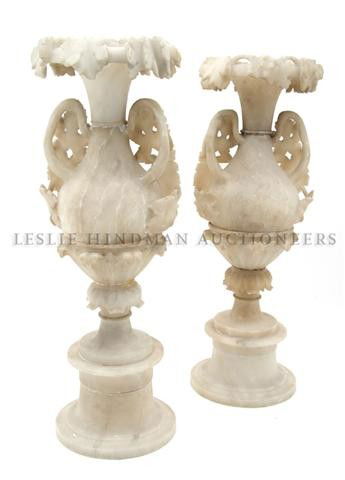 A Pair of Italian Alabaster Urns, Height 20 1/2 inches.: A Pair of Italian Alabaster Urns, of baluster handled form, having allover scrolling vine decoration raised on a socle. Height 20 1/2 inches.