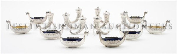 An Assembled Set of Eight Scandinavian Silver Salts, Wi: An Assembled Set of Eight Scandinavian Silver Salts, each in the form of a stylized Viking ship, six with cobalt glass liners, two with clear liners, together with eight horn form casters. Width 3 3/8