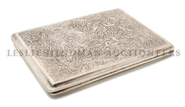 An Iranian Silver Cigarette Case, Height 4 1/2 x width : An Iranian Silver Cigarette Case, of rectangular form, having allover bird and scrolling foliate decoration; approximate weight 5.48 ozt. Height 4 1/2 x width 3 1/4 inches.