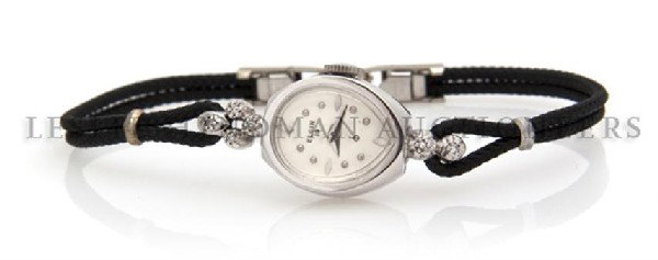 A 10 Karat White Gold Lady's Dummy" Wristwatch, Lord El: A 10 Karat White Gold Lady's "Dummy" Wristwatch, Lord Elgin, white dial, applied lozenge and dot numerals, pear shape case, black cord bracelet with silver-tone clasp, no movement. Property from the M