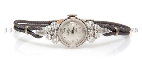 A 14 Karat White Gold and Diamond Lady's Dummy" Wristwa: A 14 Karat White Gold and Diamond Lady's "Dummy" Wristwatch, Lord Elgin, containing ten round brilliant diamonds weighing approximately 0.82 carat total, matte silvered dial, applied Arabic, baton, an