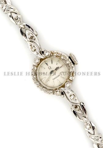A 14 Karat White Gold and Diamond Mechanical Ladies Wat: A 14 Karat White Gold and Diamond Mechanical Ladies Watch, Omega, containing 37 single cut diamonds weighing approximately 0.40 carat total, matte silvered dial, silvered baton numerals, silvered swor