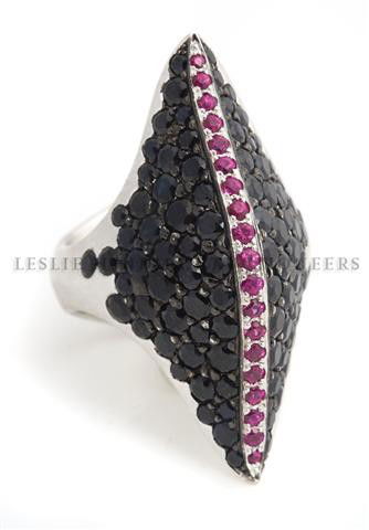 An 18 Karat White Gold, Black Sapphire and Ruby Ring, S: An 18 Karat White Gold, Black Sapphire and Ruby Ring, Stephen Webster, containing numerous small round black sapphires, and numerous small round rubies. Stamp: SW, English hallmarks. 9.80 dwts. Size 6