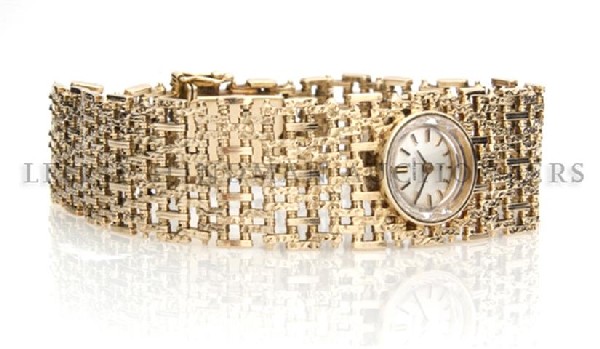A 14 Karat Yellow Gold Mechanical Wristwatch, Seiko, 29: A 14 Karat Yellow Gold Mechanical Wristwatch, Seiko, silvered dial, baton numerals and hands, textured link bracelet. 29.80 dwts. Property from the Estate of Ruth Rapfogel, Chicago, Illinois