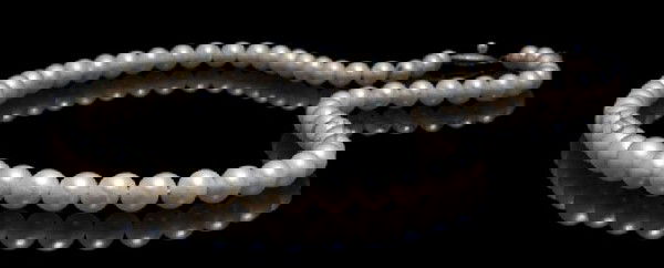A 10 Karat White Gold and Cultured Pearl Single Strand : A 10 Karat White Gold and Cultured Pearl Single Strand Necklace, containing pearls measuring approximately 5.79-8.63 mm in diameter. Length: 18 inches. Property from the Estate of Mrs. John H. (Len W.