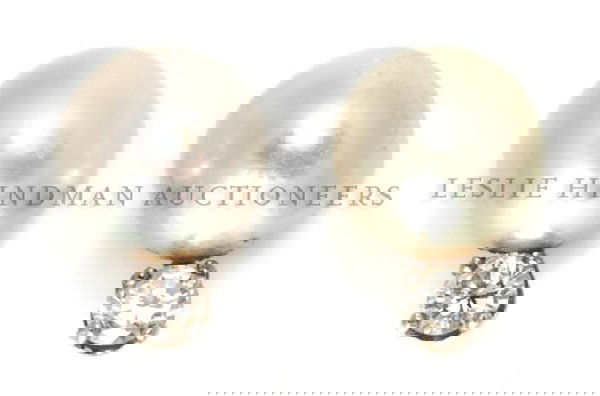 A Pair of 14 Karat Yellow Gold, Cultured Pearl and Diam: A Pair of 14 Karat Yellow Gold, Cultured Pearl and Diamond Screwbacks Earrings, containing two pearls measuring approximately 8.30 mm in diameter and two round brilliant cut diamonds weighing approxim