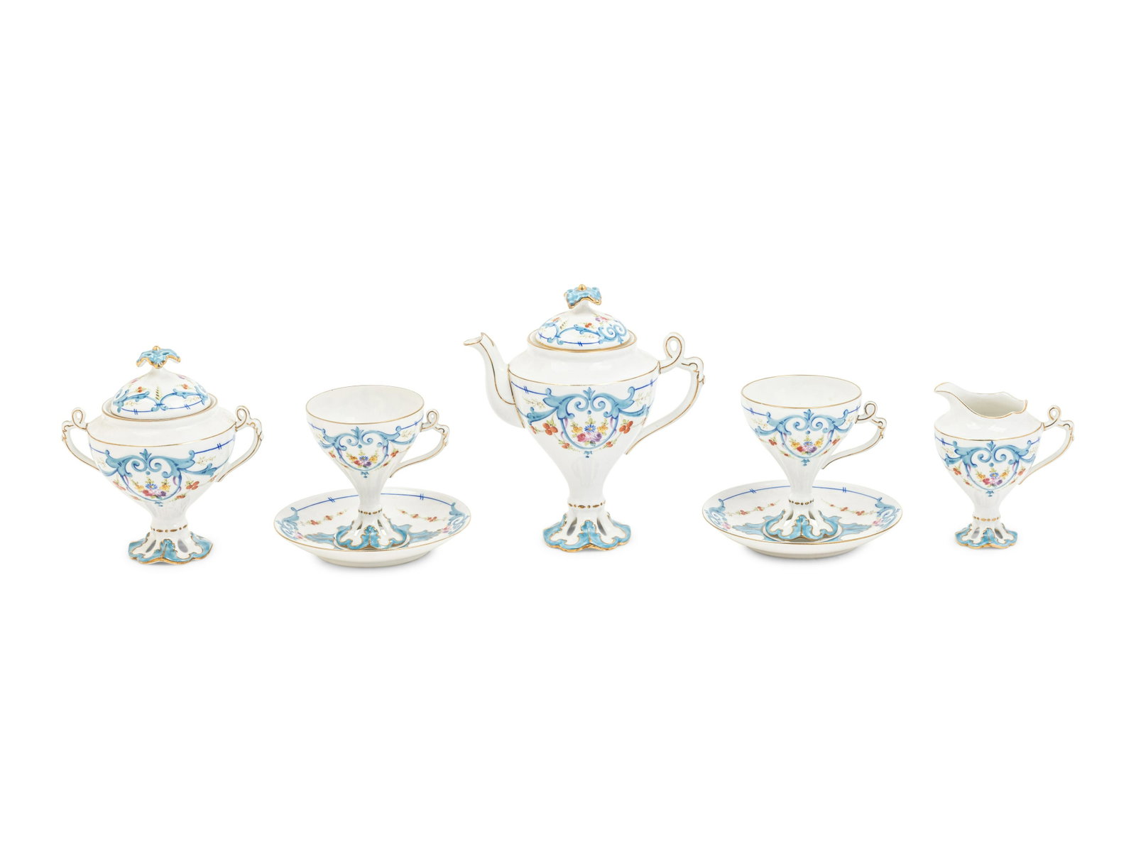 A Limoges Porcelain Tete-a-Tete: A Limoges Porcelain Tete-a-Tete comprising a teapot, sugar, creamer, 2 teacups and 2 saucers; 7 items total. Height of teapot 7 inches.