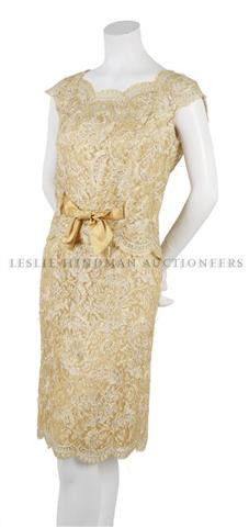 An Oleg Cassini Gold Lace Ensemble,: An Oleg Cassini Gold Lace Ensemble, 1960s, dress with attached vest, scalloped edges, pegged skirt, fully lined. Labeled: Oleg Cassini.