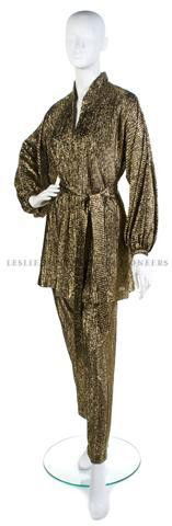 A Halston Gold Metallic Evening Suit,: A Halston Gold Metallic Evening Suit, comprised of a long tunic and pants, belted waist. Labeled: Halston IV.