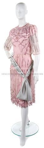 A Zandra Rhodes Pink Chiffon Dress,: A Zandra Rhodes Pink Chiffon Dress, 1987, from the 'Secrets of the Nile' collection, with bead and rhinestone detail at bodice, grey sash belt, pink slip. Labeled on belt: Zandra Rhodes.